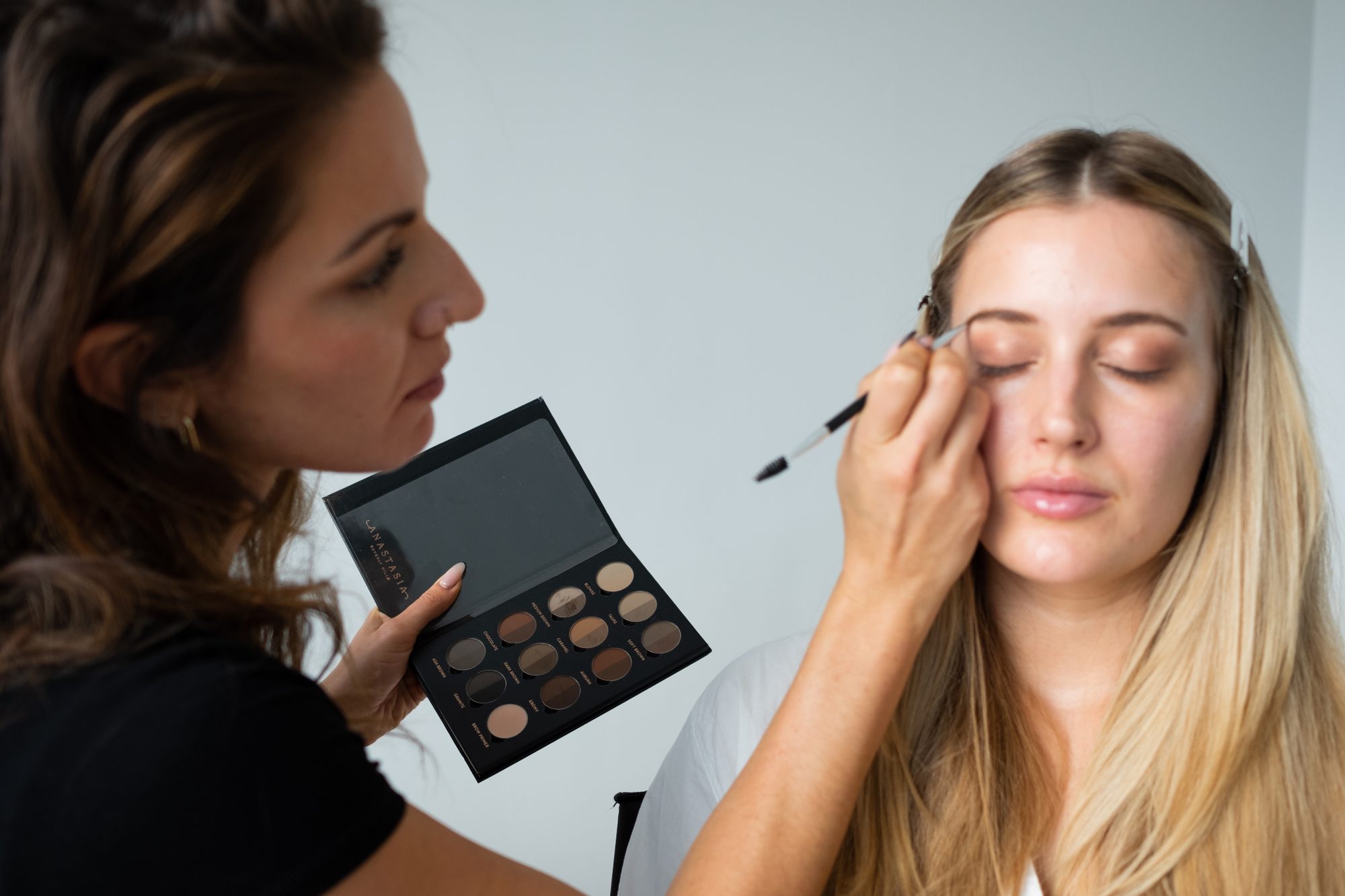 Lauren shaping a client's brows